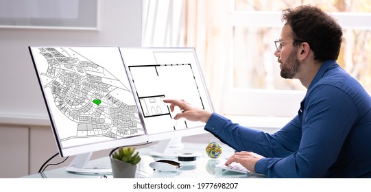 Developer Looking At Land Plot Map And Cadastre Plan