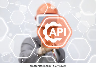 Developer Man In Safety Helmet And Virtual Reality Glasses Touched API Gear Icon On Touch Screen. Application Programming Interface Business Industry Development Template Build Web Computer Concept.