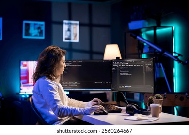 Developer in neon lit apartment implement security measures, protecting company systems and data. System administrator working from home, testing and debugging Javascript code - Powered by Shutterstock - Get 15% off with code: PIKWIZARD15