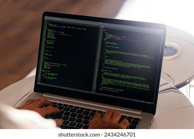 Developer programmer writing html javascript code in a laptop. Close up view.