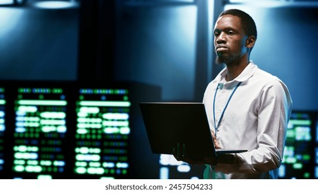 IT developer setting up data center advanced firewalls, intrusion detection systems and regular security updates. Cybersecurity expert preventing hacking, malware, and DDoS attacks - Powered by Shutterstock