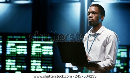IT developer setting up data center advanced firewalls, intrusion detection systems and regular security updates. Cybersecurity expert preventing hacking, malware, and DDoS attacks