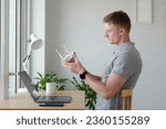 Developer setting new router in his home office