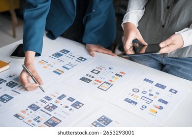 Developer team brainstorming user interface and experience designs for mobile application ux ui graphic prototype 