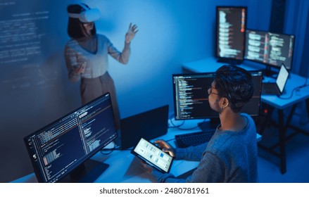 developer uses a VR headset to interact with projected interface designs, while colleagues discuss and code on screens, highlighting the integration of virtual reality and UIUX design