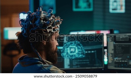 Developer using EEG headset device to upload his brain into computer, attaining immortality. Neuroscientist runs experiment, transfers consciousness into cyberspace, transhumanism concept, camera A