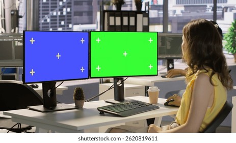 Developer using multi monitor isolated screen PC to create machine learning models that can process data to automate decision making processes. Woman programming using mockup computer, camera A