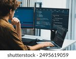 IT developer working online software development on pc monitors at modern home office on coding application screens, creating updated latest program firmware information version concept. Gusher.
