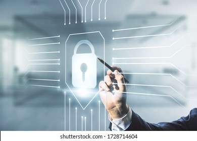 Developer's hand with pen working with virtual creative lock illustration with microcircuit on blurred office background, cyber security concept. Multiexposure