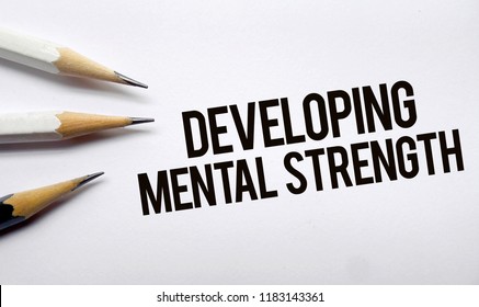 Developing Mental Strength Memo Written On A White Background With Pencils