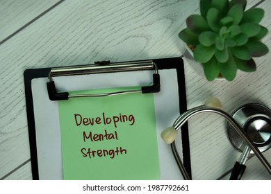 Developing Mental Strength Write On Sticky Notes Isolated On Wooden Table.