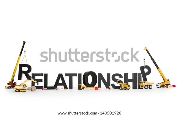 Developing relationship concept: Construction machines building up with letters the word relationship, isolated on white background.