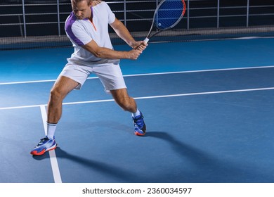 Developing speed and strength. Portrait of tennis player in motion, returning a ball. Game training on court. Concept of active life, team game, energy, sport, competition. Copy space for ad. - Powered by Shutterstock