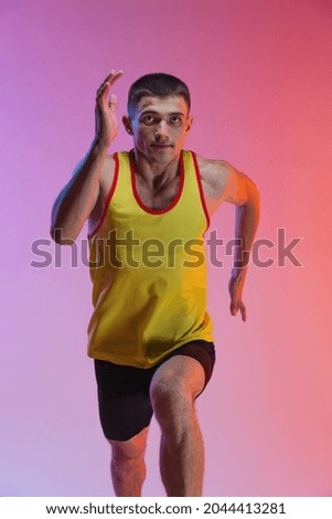 Developing speed. Young man, professional athlete, runner training isolated over gradient studio background. Maintaining health and strength. Concept of sport, healthy lifestyle, motion, ad.