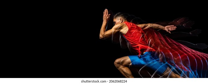 Developing strength. Young male athlete, professional runner in motion isolated over black background. Stroboscope effect. Concept of sport, action, energy, health, movement. Copy space for ad