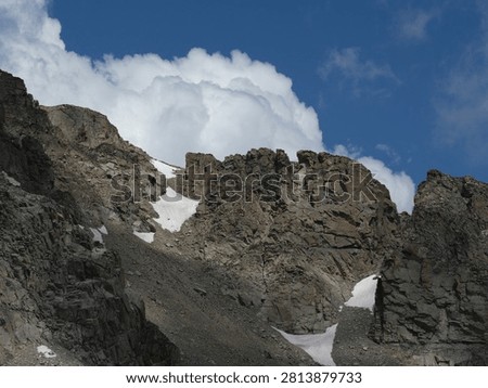 Developing summer clouds above alpine cliffs on Pawnee Pass Trail in Colorado