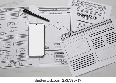 Developing UI design. Sketches of website wireframes, smartphone and pen on white marble table, top view