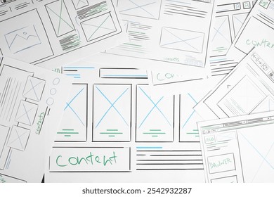 Developing UI design. Sketches of website wireframes on as background, top view