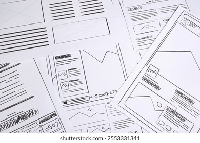 Developing UI design. Sketches of website wireframes as background, above view