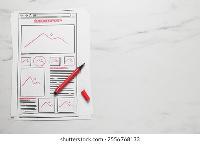 Developing UI design. Sketches of website wireframes and felt pen on white marble table, top view. Space for text