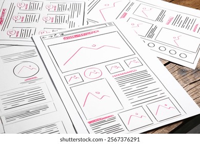Developing UI design. Sketches of website wireframes on wooden table, closeup