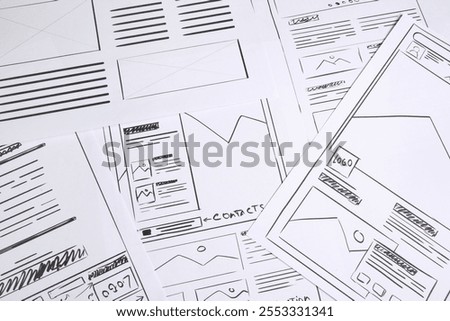 Developing UI design. Sketches of website wireframes as background, above view