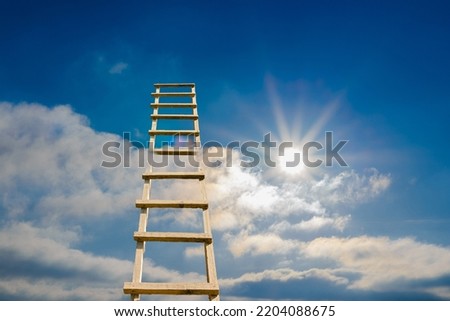 Development, Attainment ,Motivation. Career Growth Concept.Wooden Ladder Leading To A Sun,Blue Cloudy Sky.Copy space.
