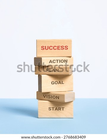 Development business growth processes are staged of wooden blocks with words start, vision, goal, plan, action and success. Business progress, strategic development of a company, startup.