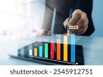 Development corporate to business success and achievement in 2025 year.Business plan in company 2025.Businessman touching growth chart from success year 2025.