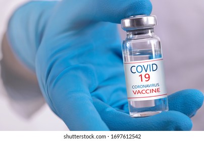 Development and creation of a coronavirus vaccine COVID-19 .Coronavirus Vaccine concept in hand of doctor blue vaccine jar. Vaccine Concept of fight against coronavirus. - Shutterstock ID 1697612542