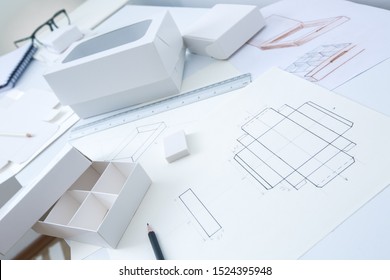 Development design drawing packaging. Desktop of a creative person making cardboard boxes. - Shutterstock ID 1524395948