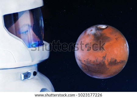 The development of Mars, concept. Astronaut, looking at the planet Mars. Elements of this image furnished by NASA.