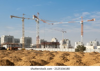 Development, new construction in the south district of Israel, new apartment buildings. Building new site with heaps of ground in front.