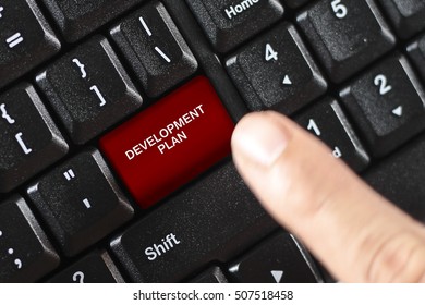 DEVELOPMENT PLAN word on red keyboard button