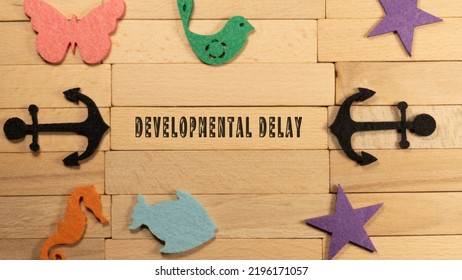 Developmental Delay Inscribed On Wood Patterned Surface. Education And Child Psychology.