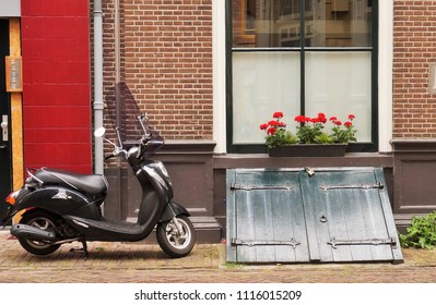 Deventer, Netherlands - June 19, 2018: scooter parked against the wall