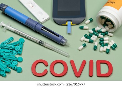 Device To Measure Blood Glucose, Vitamin D Box And The Word Covid Written In Green Background, Top View