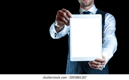 Device mockups. Businessman holding mobile tablet blank screen. Smart technology device mock up isolated on black banner background. Mockup for application or website design project