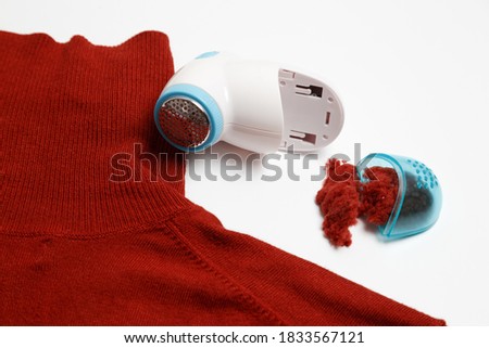 Device for removing lint from wool clothes. Golf with fuzz ball isolated on white background.