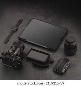 Devices Mockup Template. Video Accessories On A Dark Structural Background. Tablet, Playback Monitor, Memory Card Holder, Lens, Video Camera And Watch
