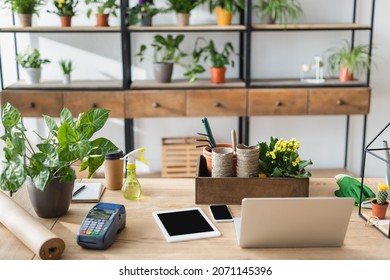 Devices, Payment Terminal And Plants On Table In Flower Shop