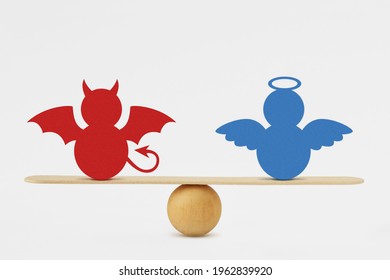 Devil and angel on balance scale - Balance between good and evil