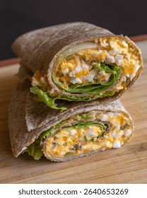 Devil egg wraps healthy breakfast on wooden cutting board. Close-up photo of a fresh, light meal with creamy devil eggs wrapped neatly. Ideal for a healthy start to the day