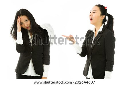 Devil side of a young Asian businesswoman laughing on angel side isolated on white background