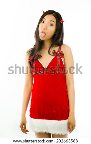 Devil side of a young Asian woman sticking out her tongue isolated on white background