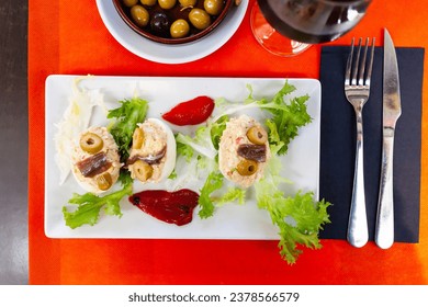 Deviled eggs with olives. Stuffed egg halves, appetizer