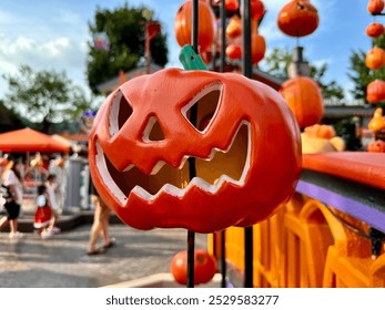 Devil-faced pumpkin hung on string decorate the venue for Halloween.