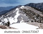 Devils Backbone Trail with snow patches near Mt Baldy in the San Gabriel Mountains above Southern California.