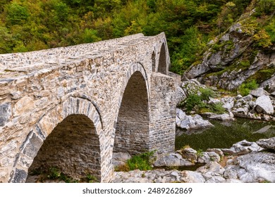 Devil's bridge is three-arched bridge over the Arda River in a narrow gorge  part of an ancient road system, Bulgaria.