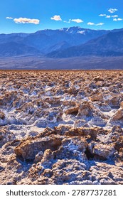 Devil's Golf Course Salt Formations and Distant Mountains Under Blue Sky
